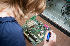student working on computer equipment